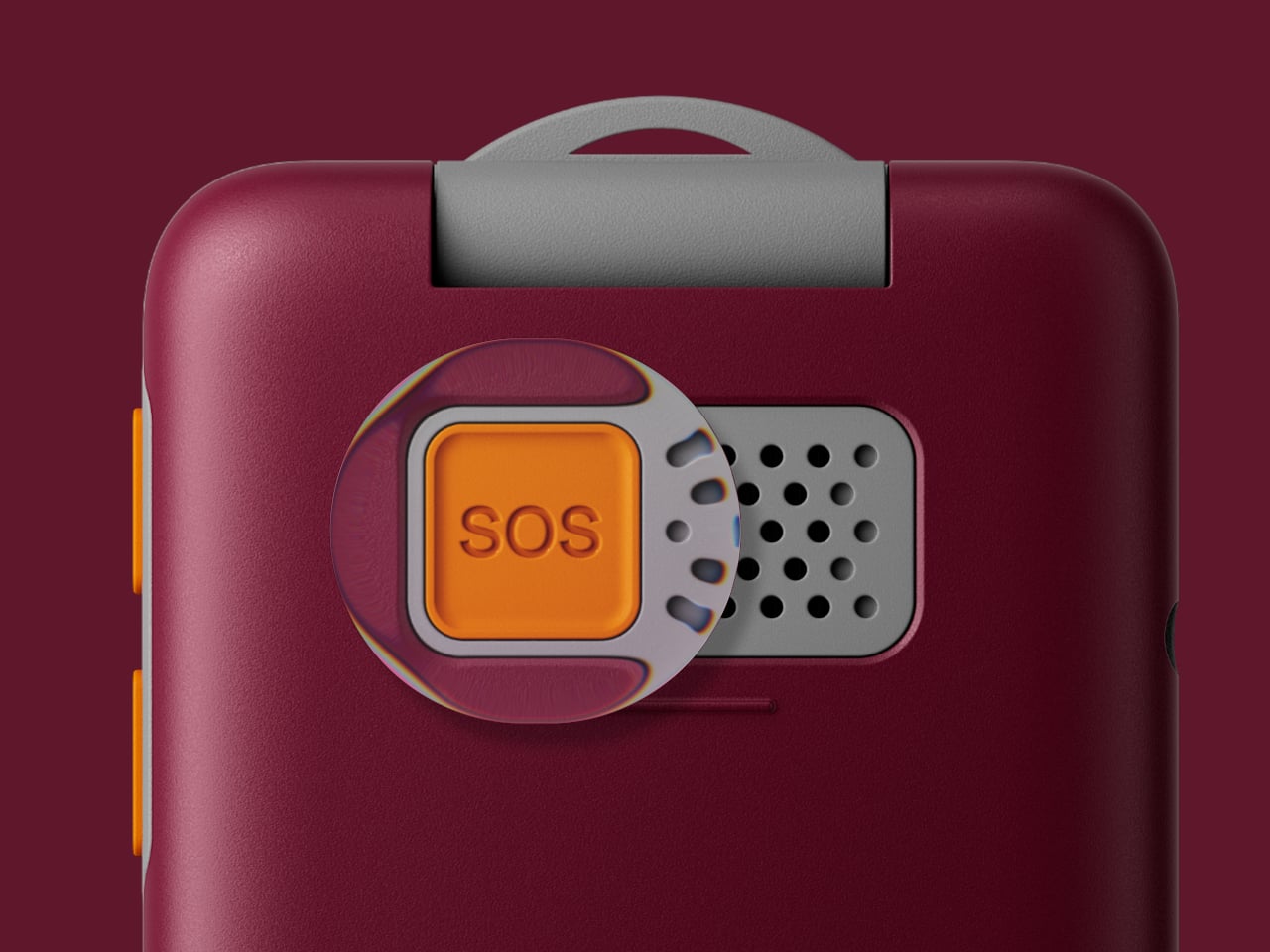 Gros plan sur le bouton SOS orange et la grille du haut-parleur au dos d'un téléphone rouge bordeaux